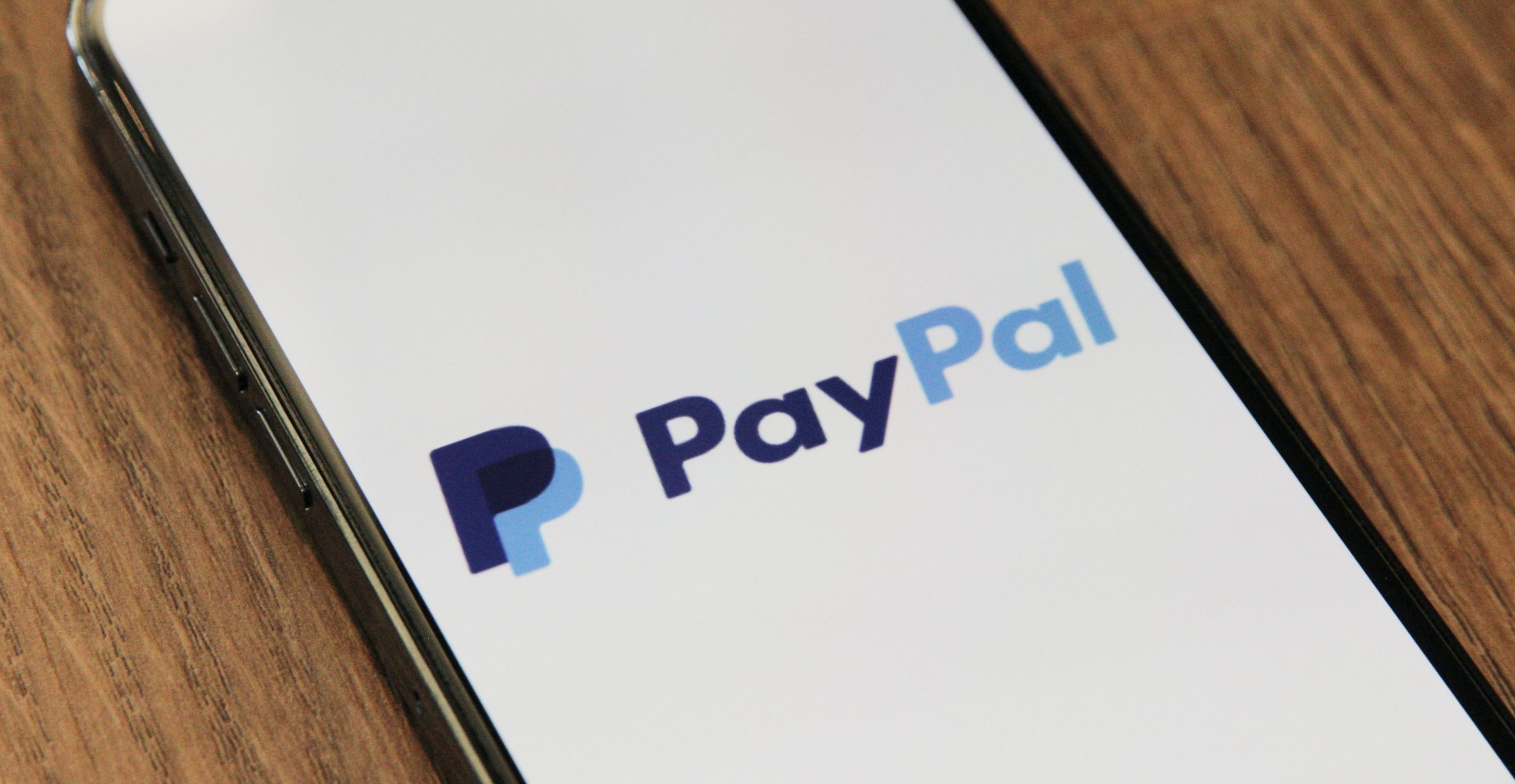 Smartphone displaying the PayPal logo.