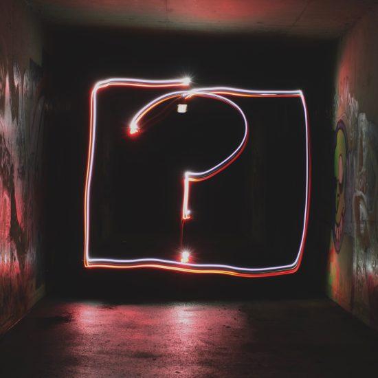 Question mark illuminated on a wall as part of an article about your brand's why.