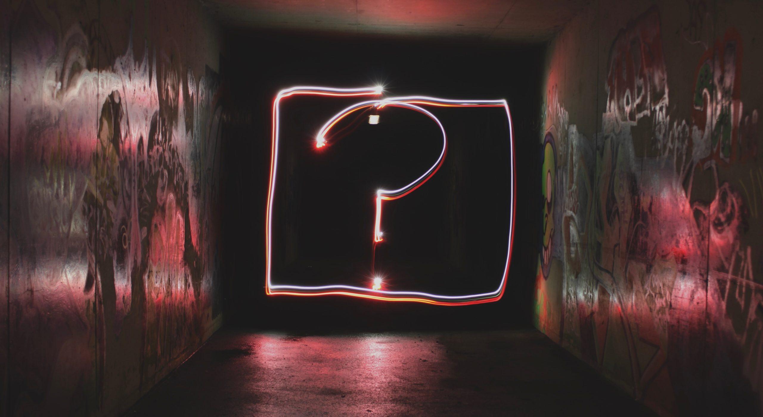 Question mark illuminated on a wall as part of an article about your brand's why.