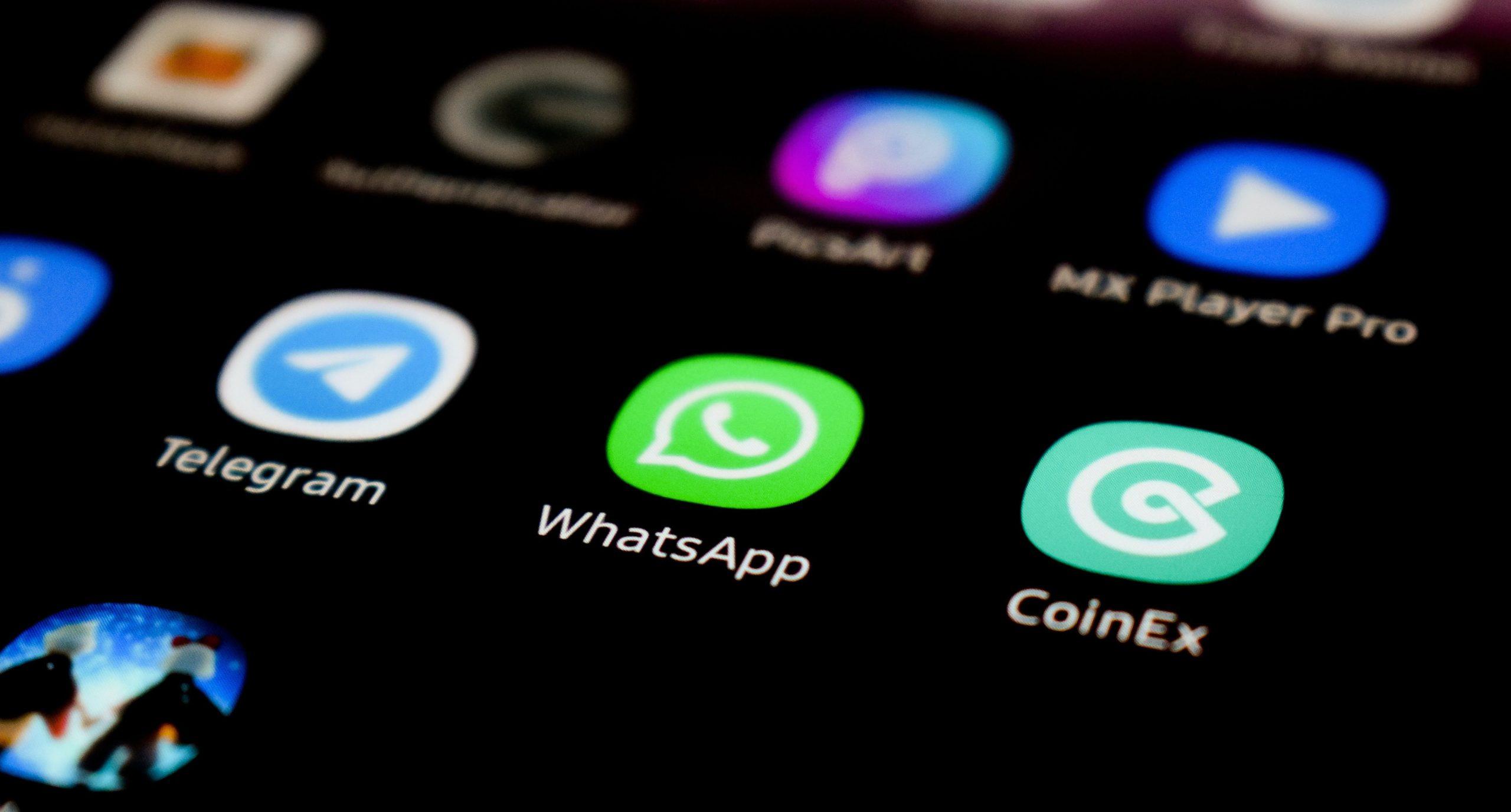 WhatsApp icon and other apps appearing on a smartphone screen.