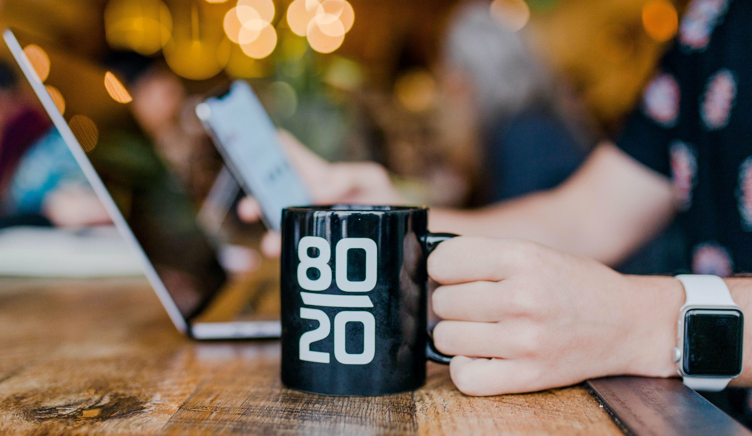 Close up of a coffee mug that displays '80-20'.