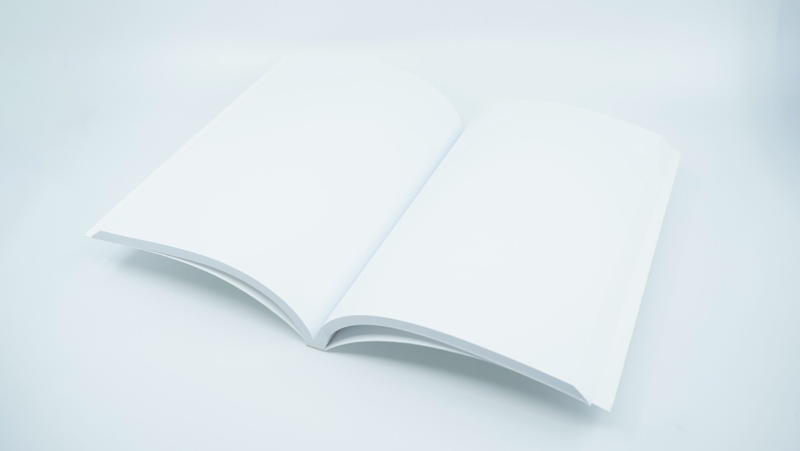 Open book with blank pages against a white background.