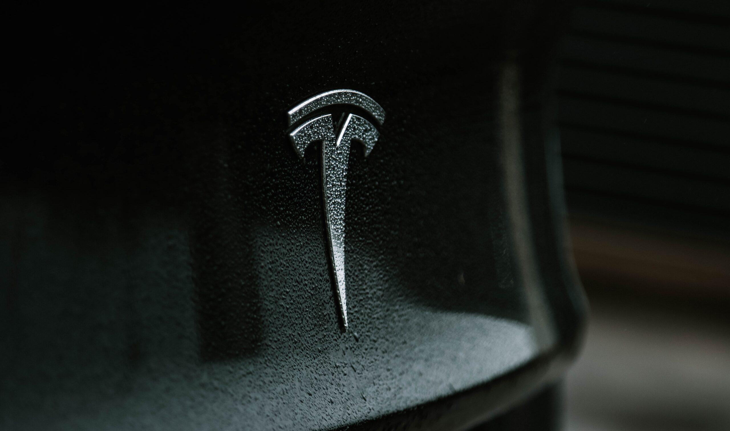 Up close image of the Tesla logo as part of an article about iconic logos.