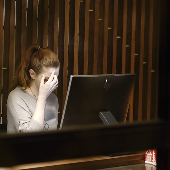 Woman in front of a computer looking stressed - as we reveal why accountants need a CRM in their lives.