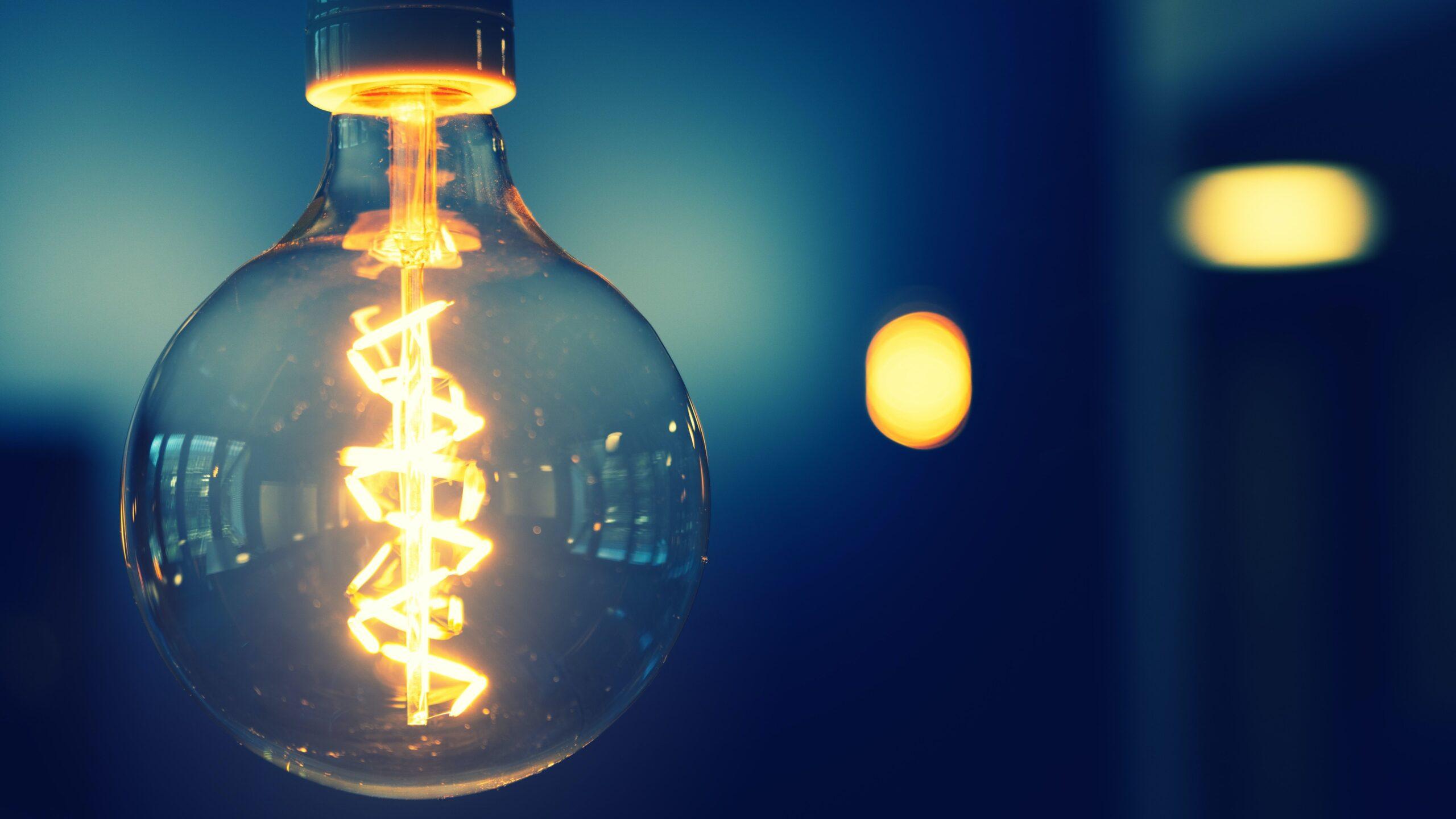 A working light bulb shining against a blurred background.