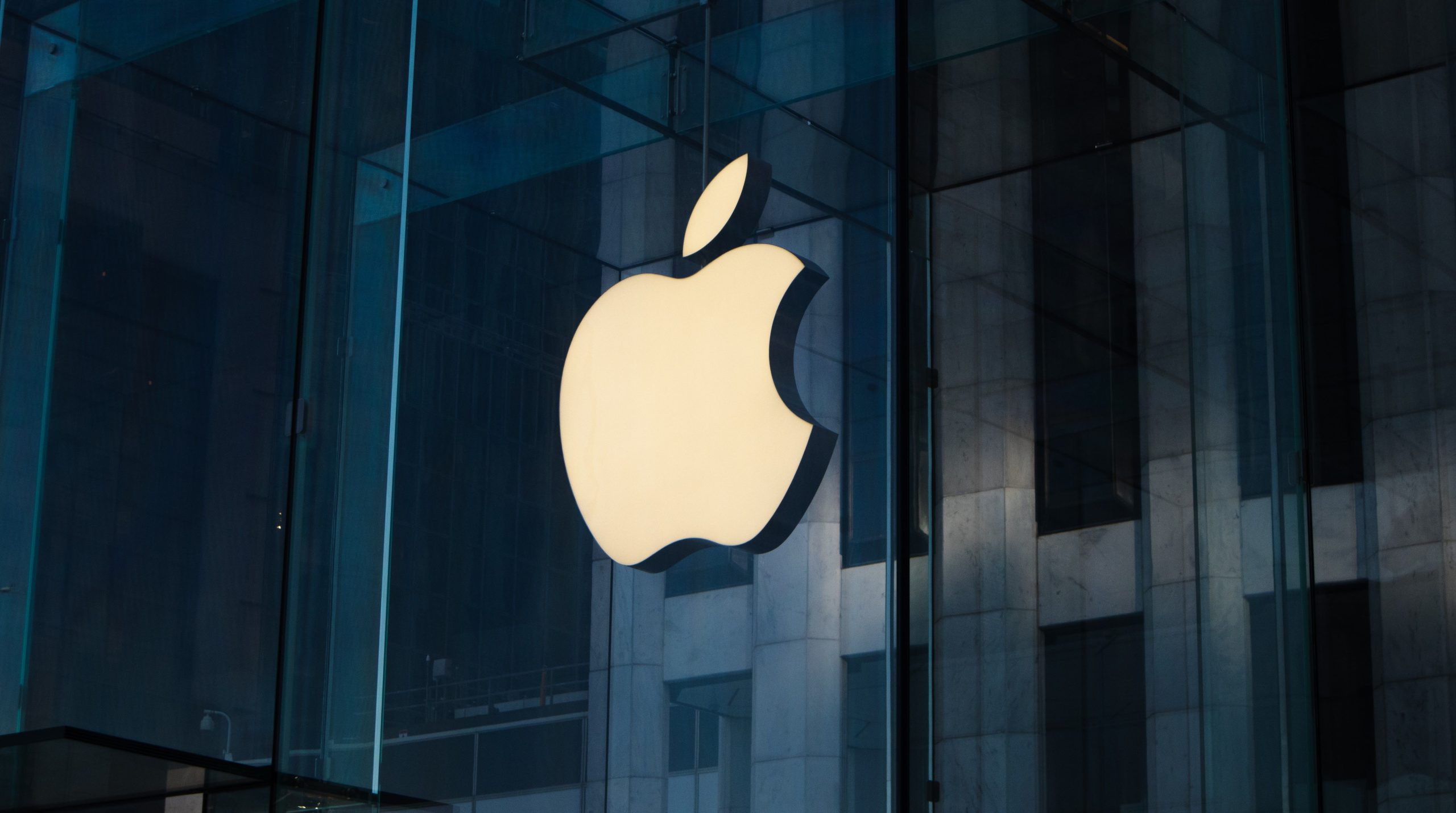 The Apple logo on a building facade.