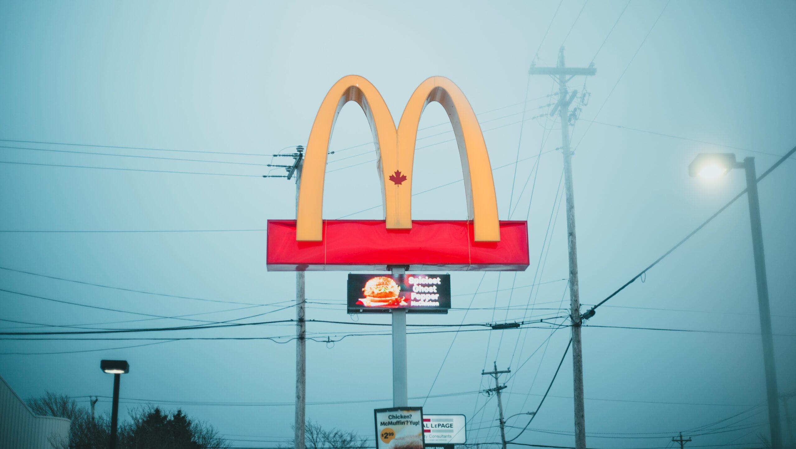 The 'golden arches' of a McDonald's restaurant against a foggy background. 