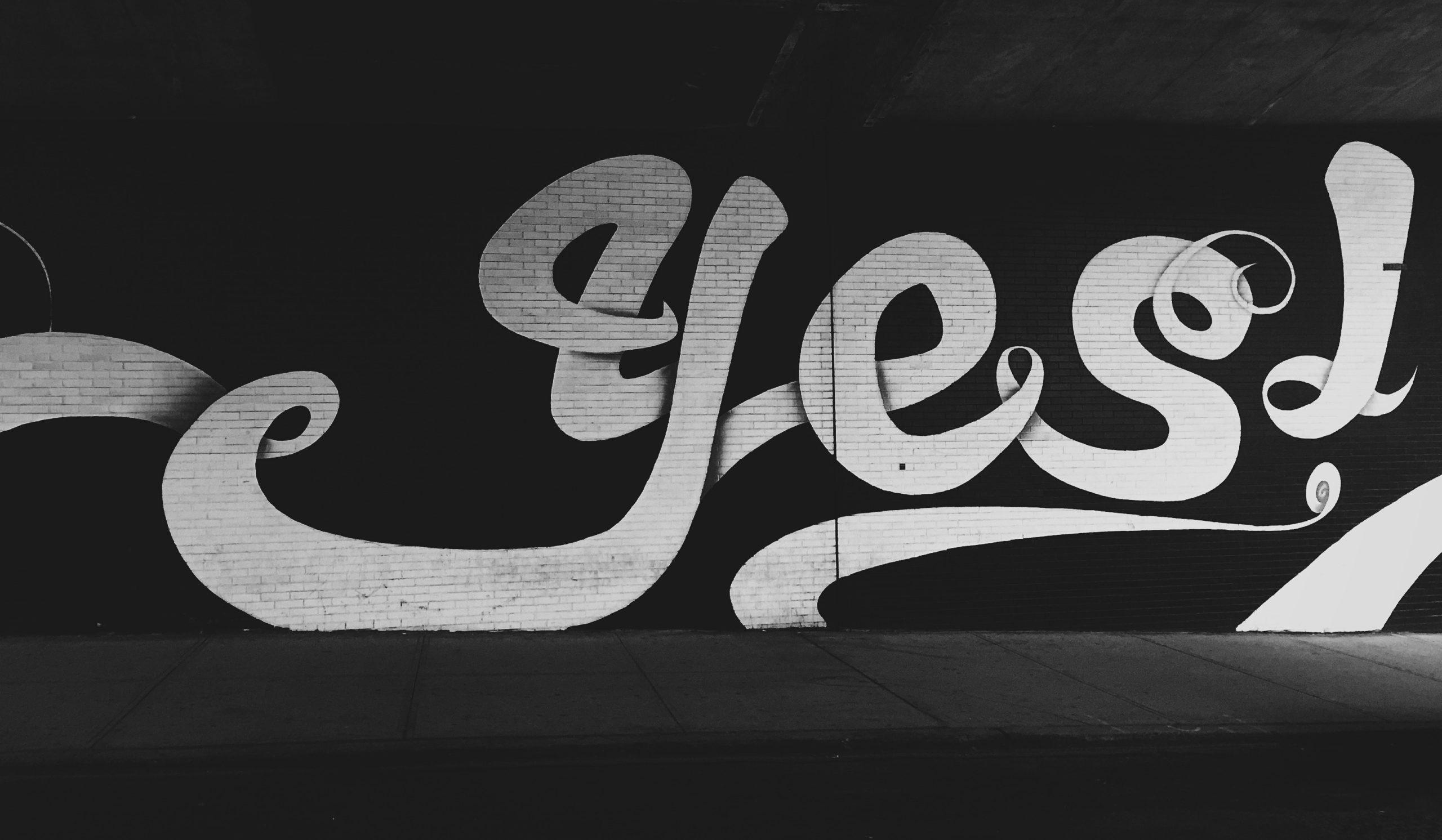 The word 'yes' written on a wall.
