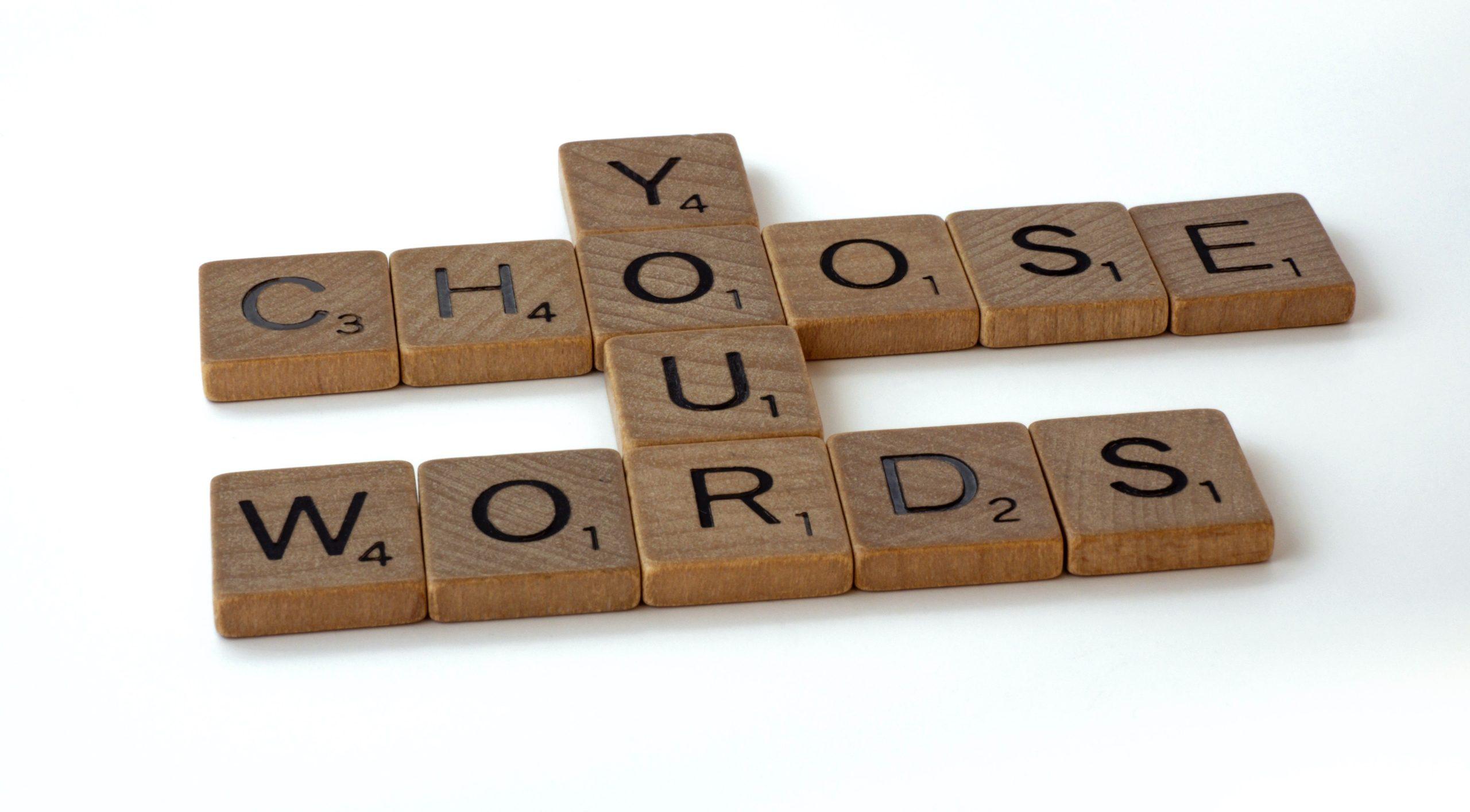 Scrabble letters organised to spell out 'Choose your words'.