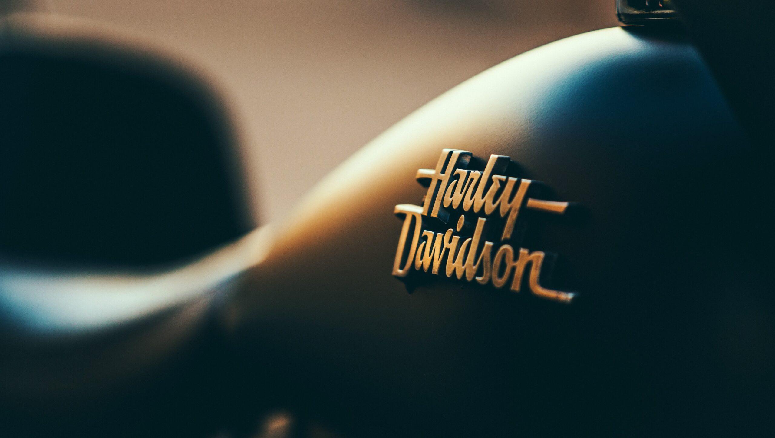 Close up of a Harley Davidson motorcycle with the brand's lettering in focus.