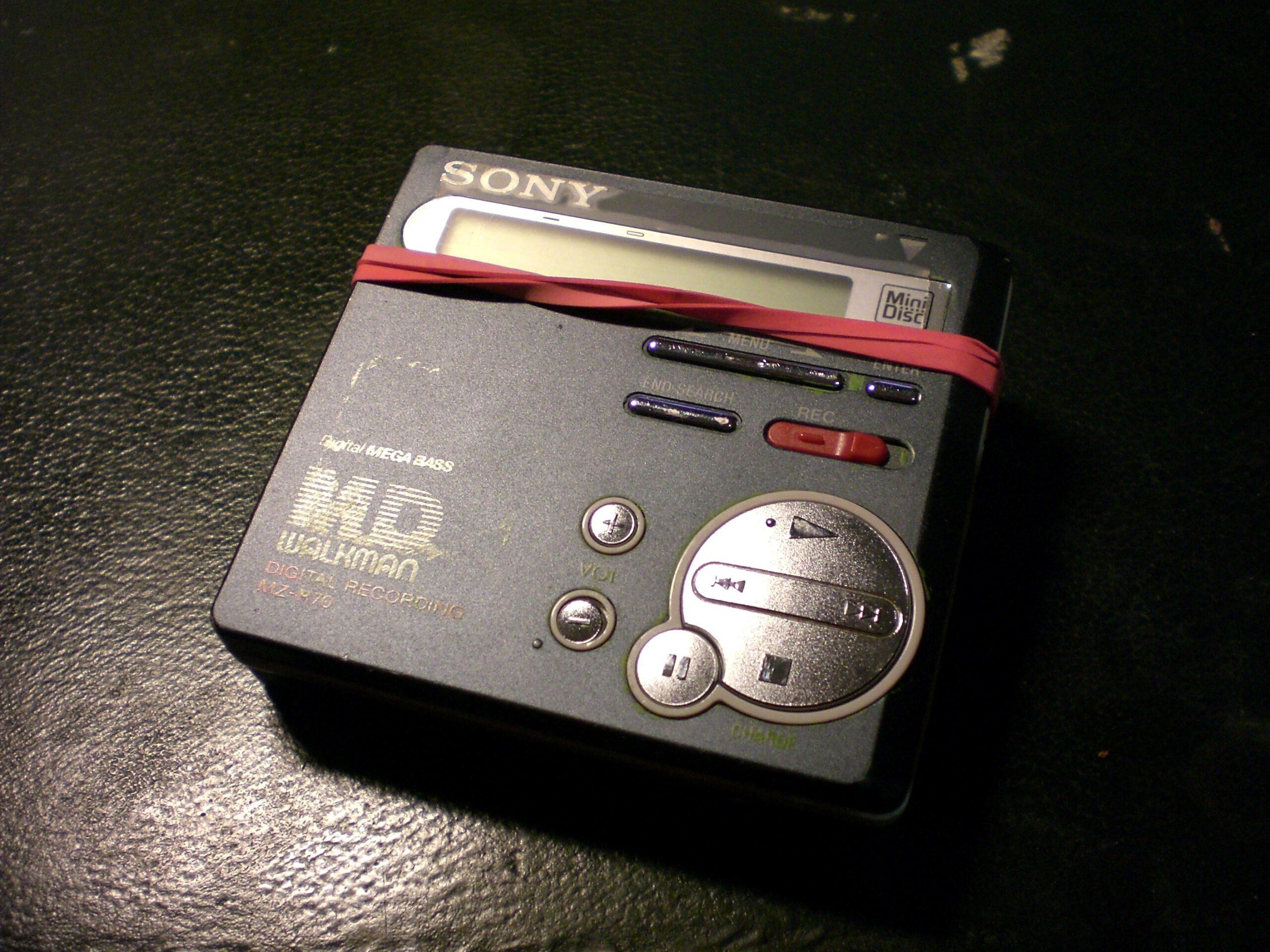 MiniDisc player placed on a black surface.