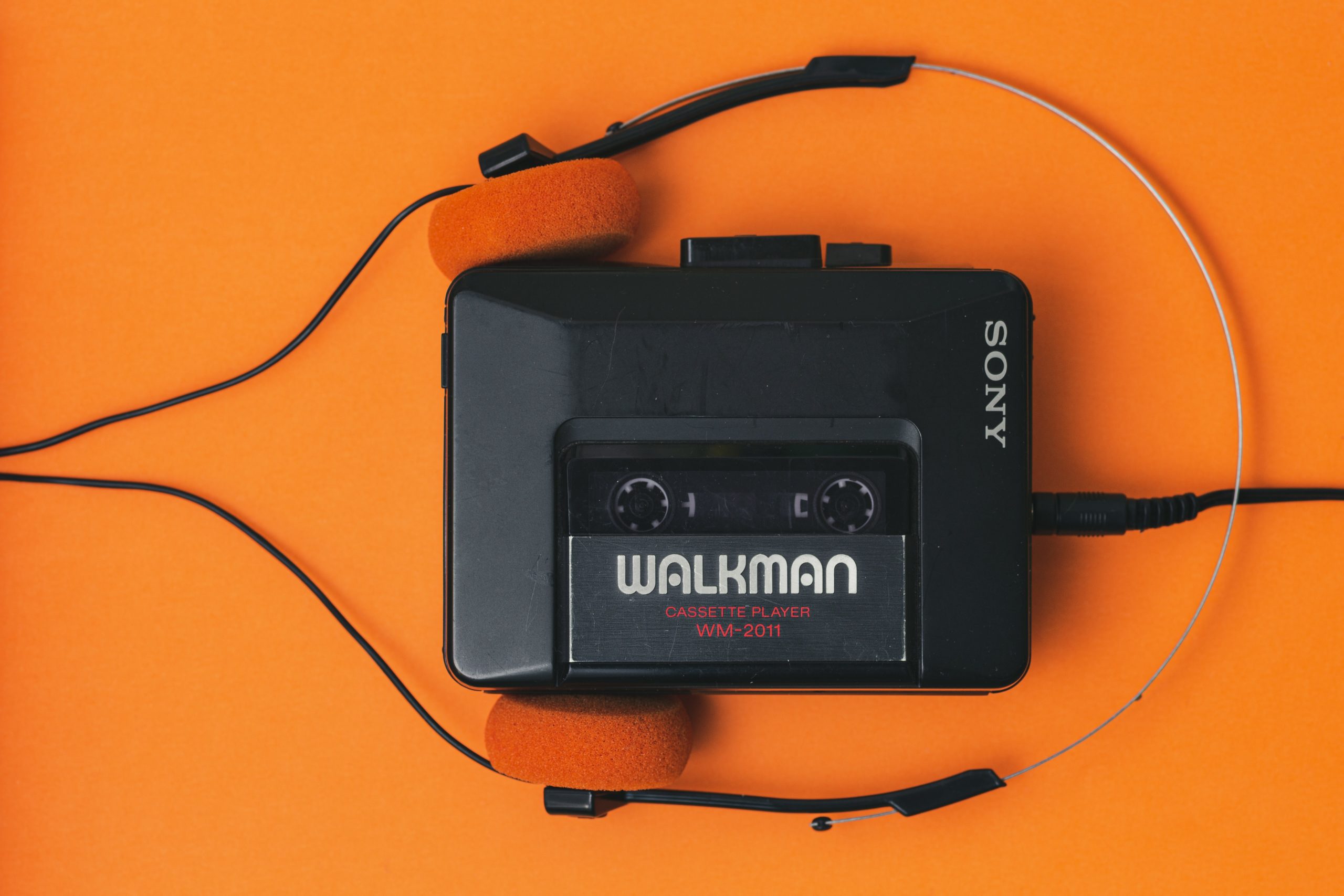 Walkman device on orange background.