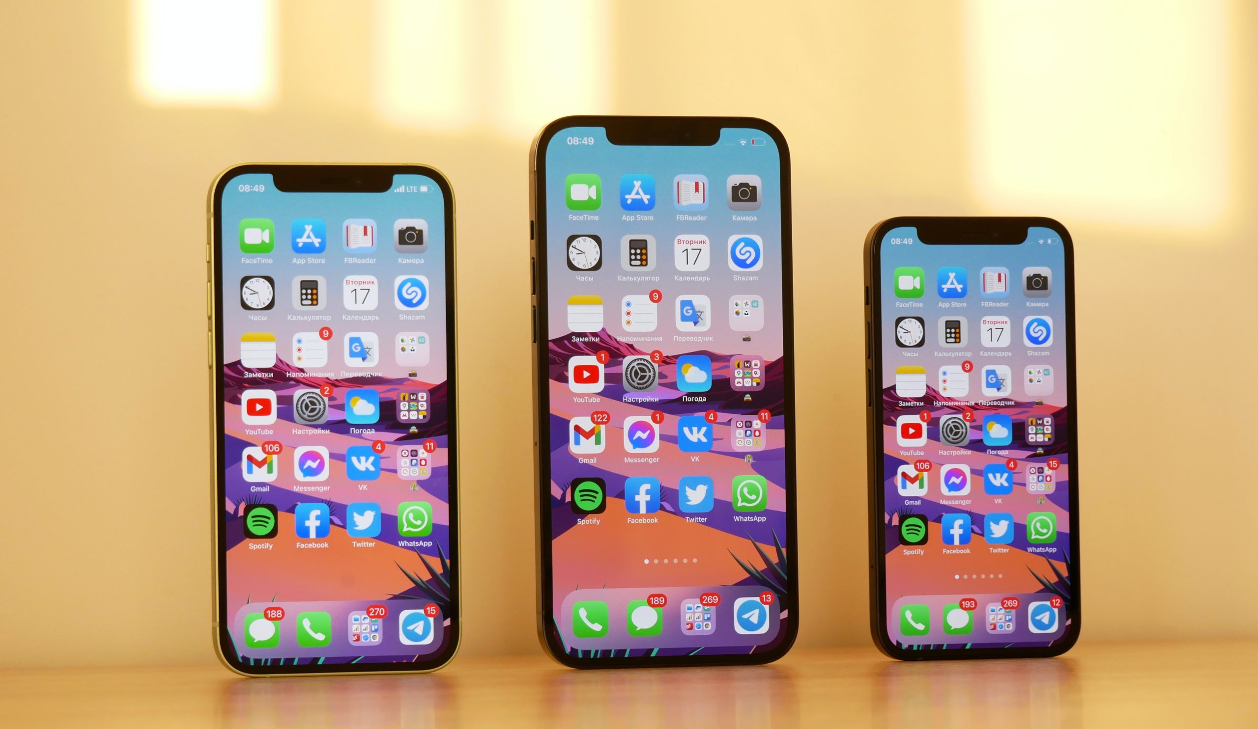 Three iPhones of varying size side by side.