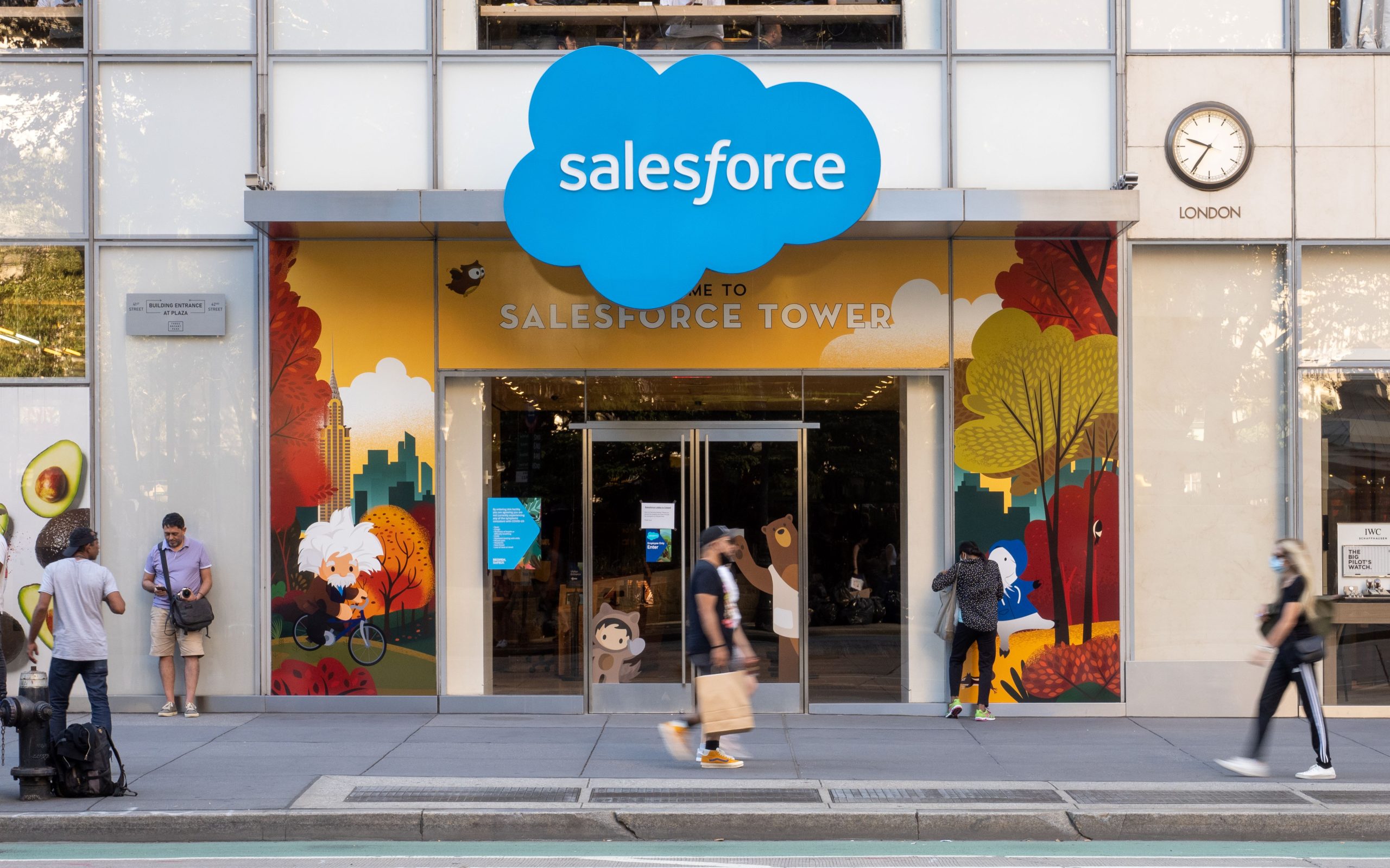 Facade of a Salesforce building as people walk by.