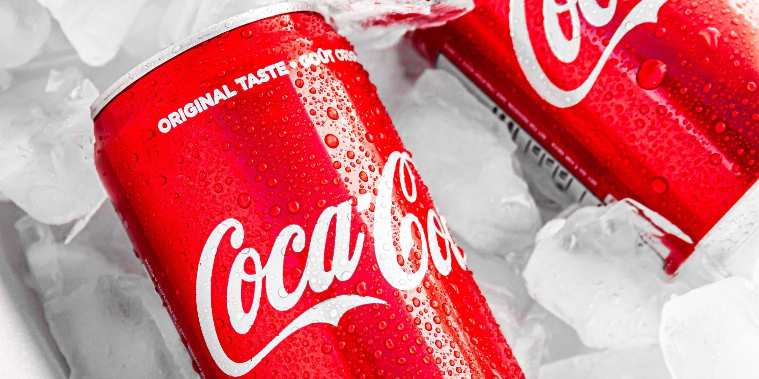 Two Coca-Cola cans on ice used to demonstrate effective brand storytelling efforts.