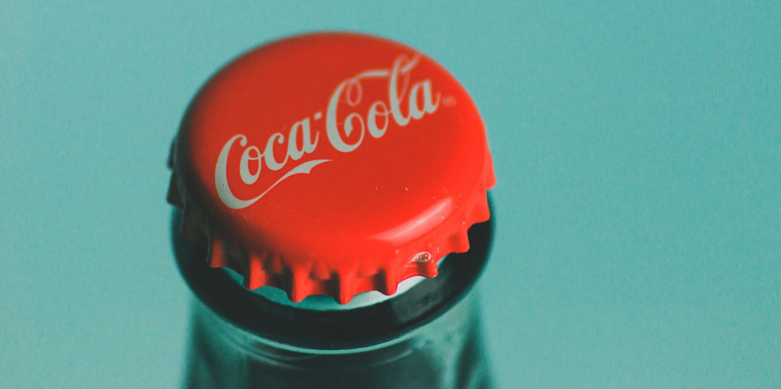 Top of an unopened Coca-Cola bottle.