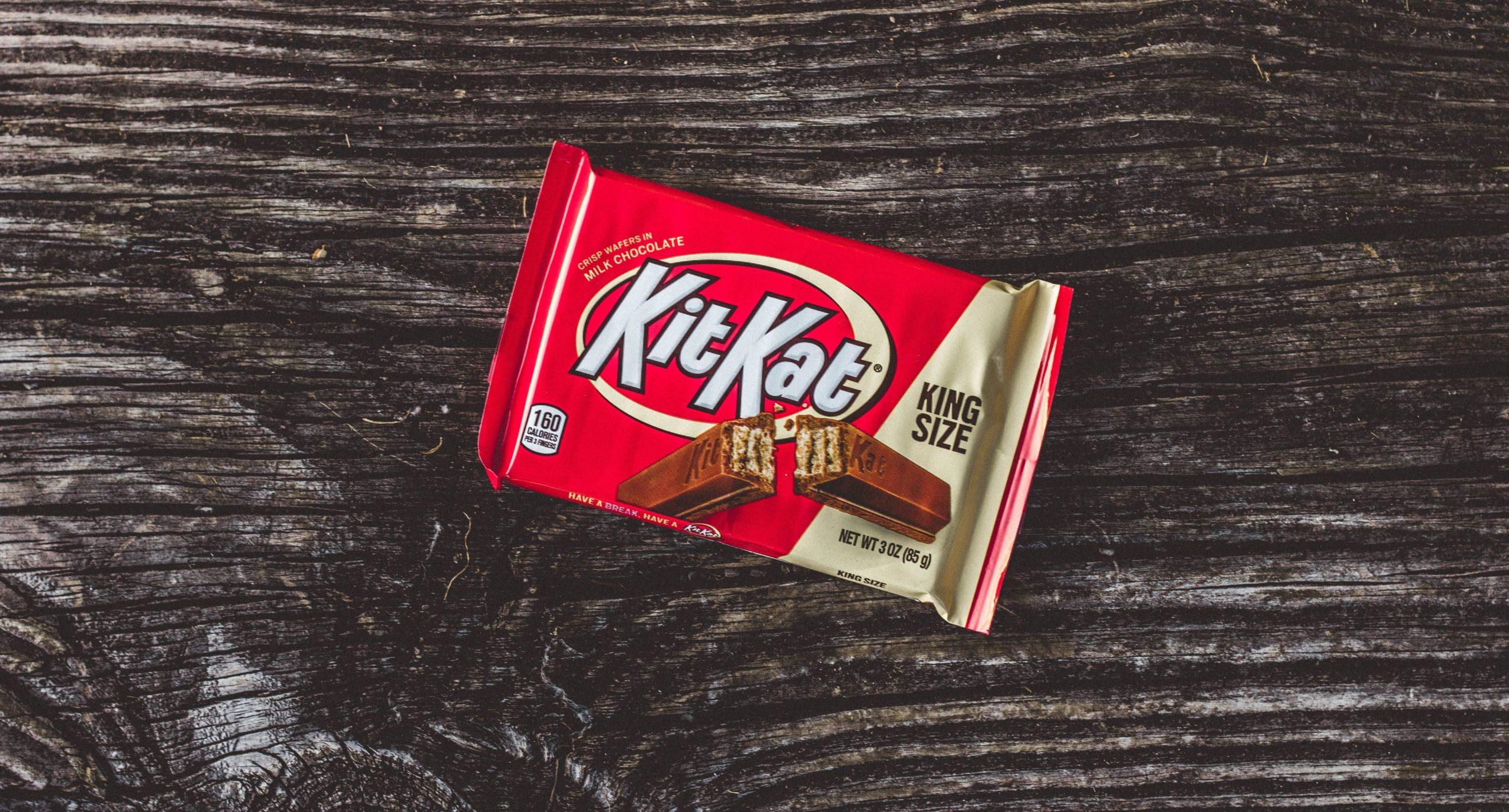 Unopened KitKat confection against a wooden background.
