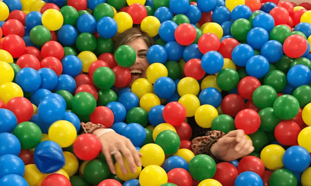 Woman in a ball pit at Googleplex.