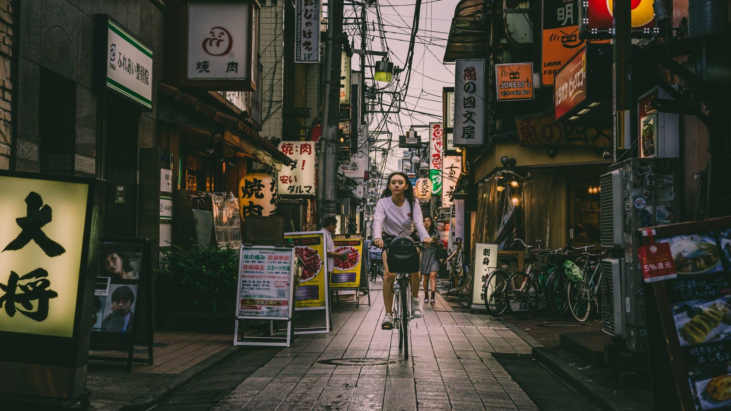 Woman riding a bicycle in Tokyo, Japan.