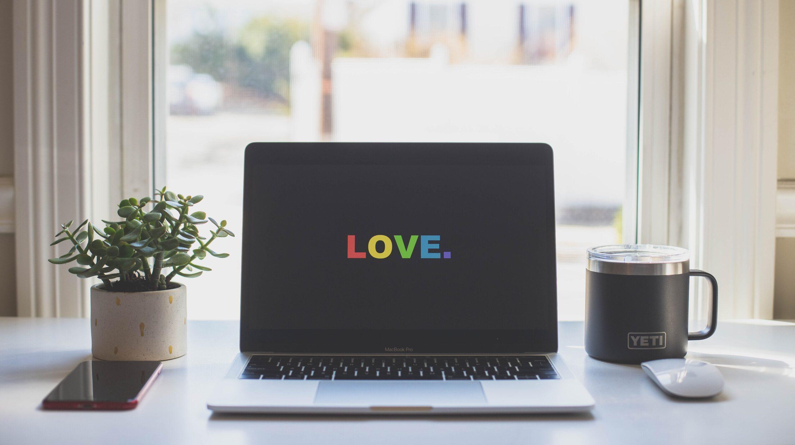Laptop screen displaying the word 'Love'.