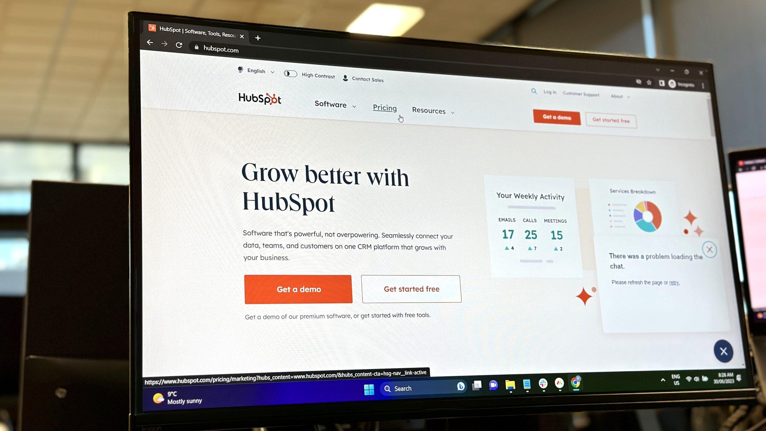 A computer monitor displaying the HubSpot homepage.