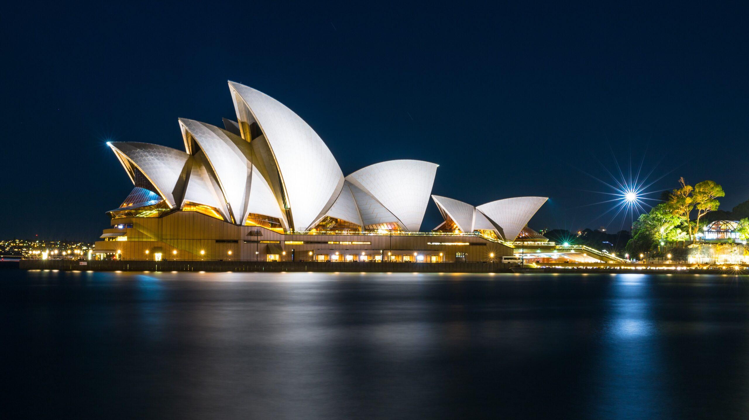 The Sydney Opera House lit up in the evening.