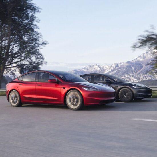 Two of the new Tesla models on a road in front of snow-capped mountains.
