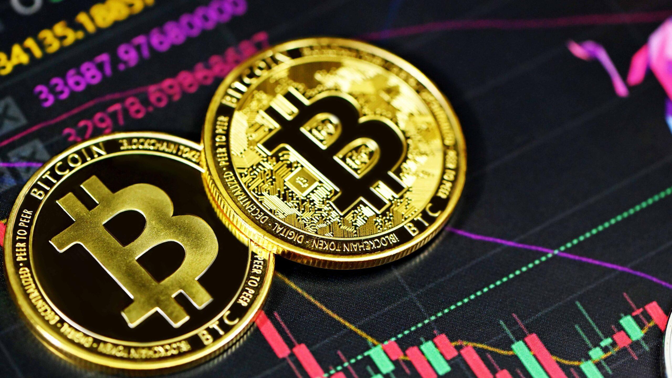 Two bitcoins against a backdrop of numbers and graphs.