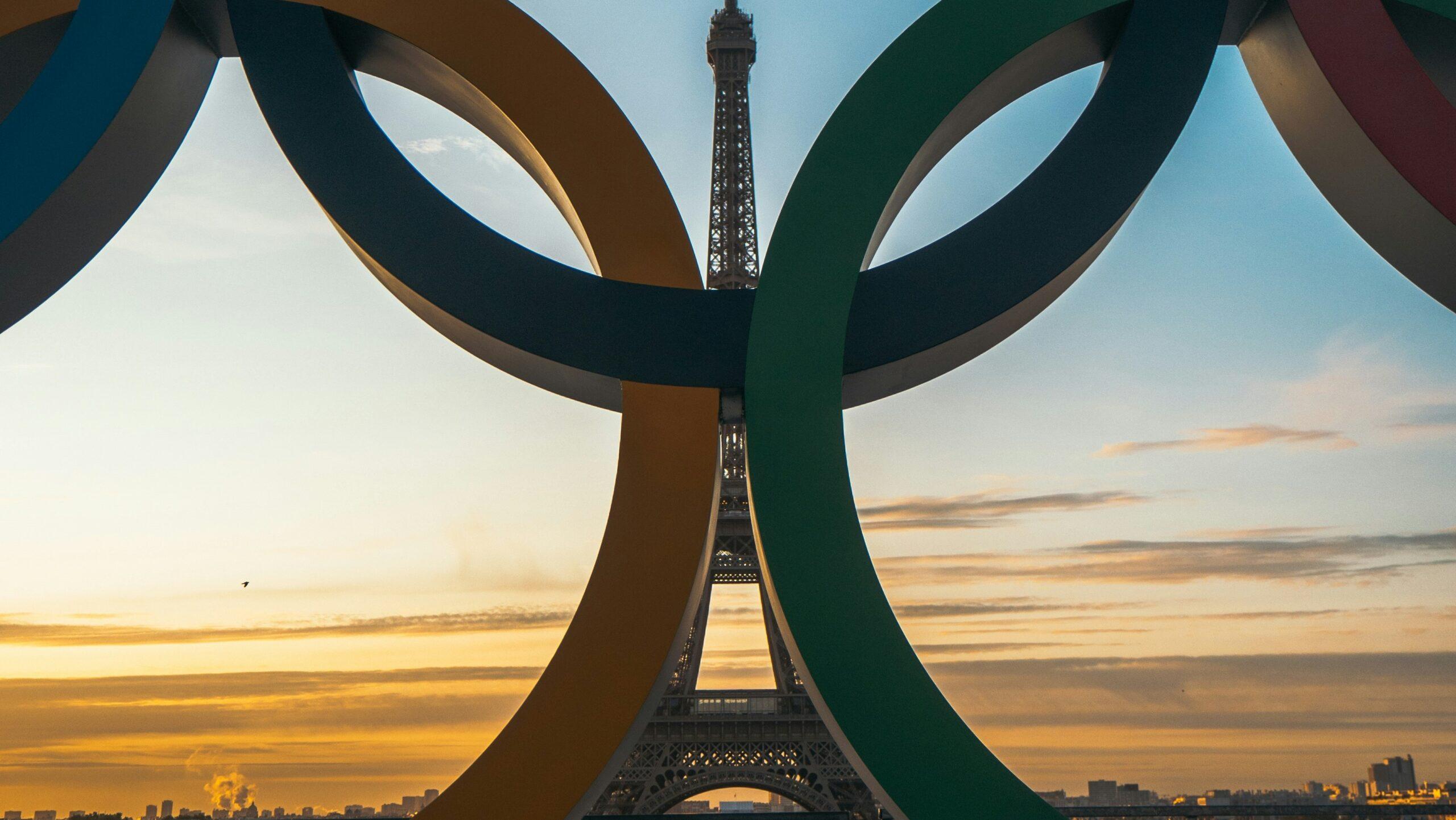 Close up of the Olympic rings in front of the Eiffel Tower in Paris, France.