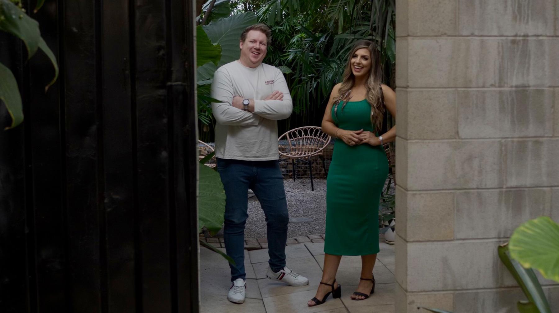 Hunt & Hawk co-founders Ryan Devlin and Sonya Vanjicki standing side by side against a garden backdrop.