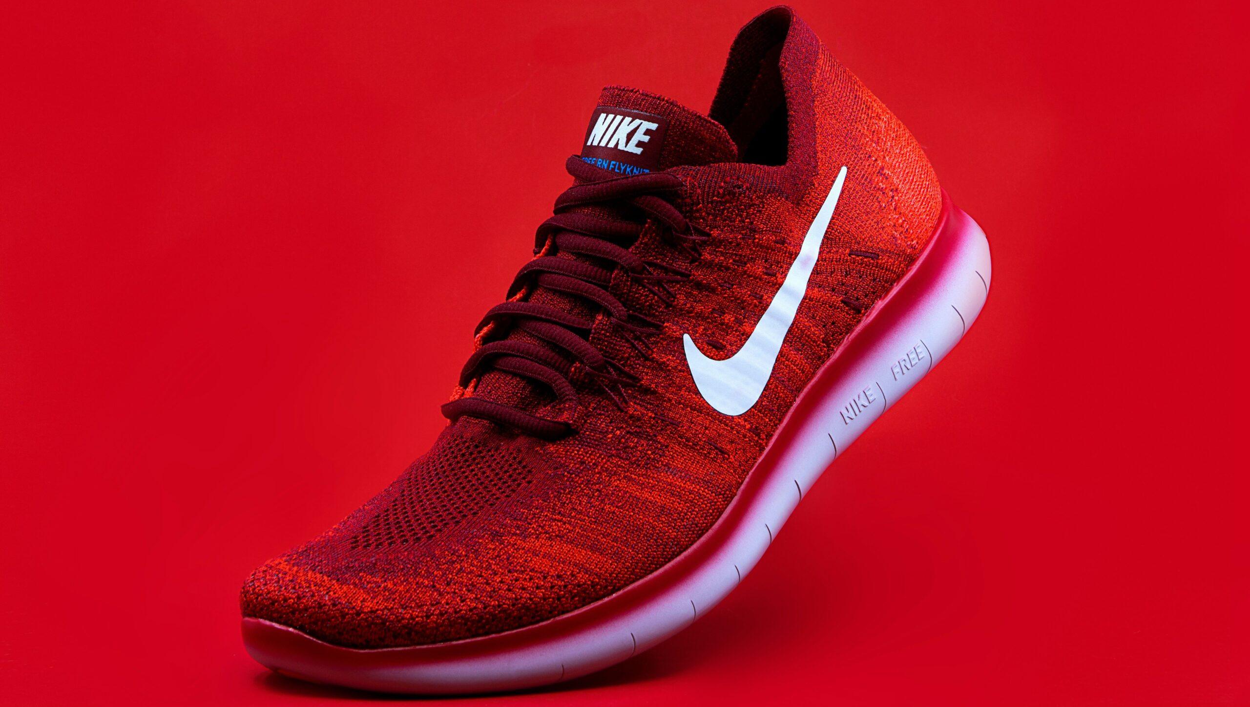 A red Nike shoe against a red background.